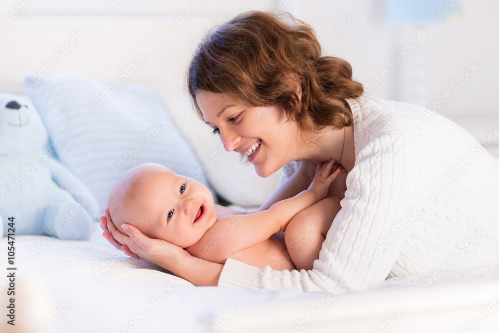 Mother and baby on a white bed Mother and baby on a white bed