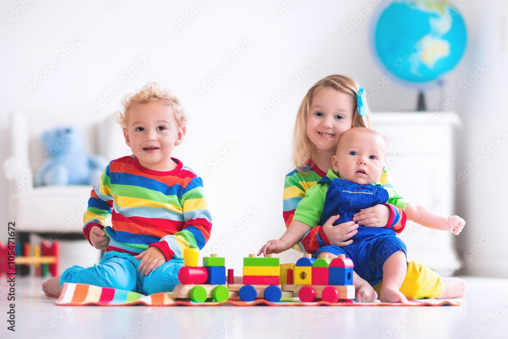 Kids playing with wooden toy train Kids playing with wooden toy train