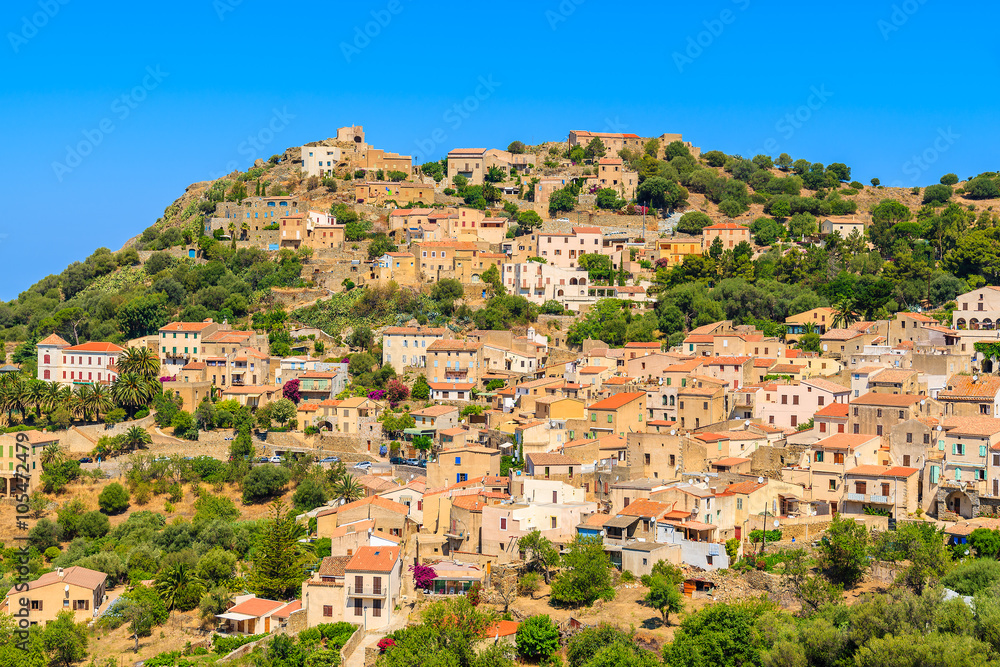 View of Corbara village with stone houses built in traditional Corsican style on top of a hill, France