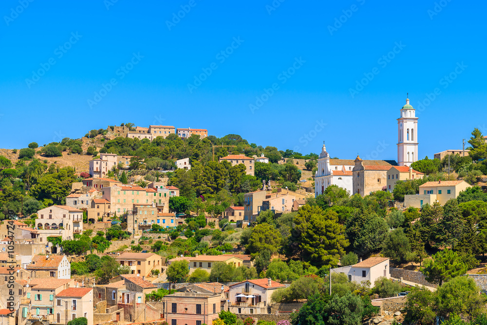 View of Corbara village with stone houses built in traditional Corsican style on top of a hill, France