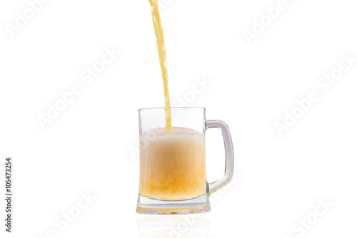 Beer pouring into half full glass isolated over white background