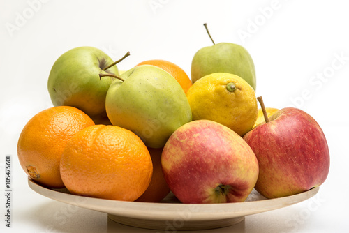 Tasty fruit orange, apples and banana on the wooden plate