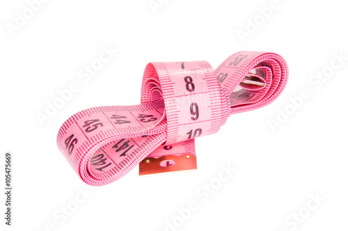 Pink flexible measuring tape hank isolated on white