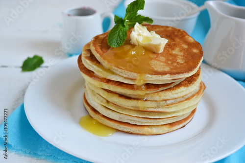 Pancakes for breakfast with butter and honey