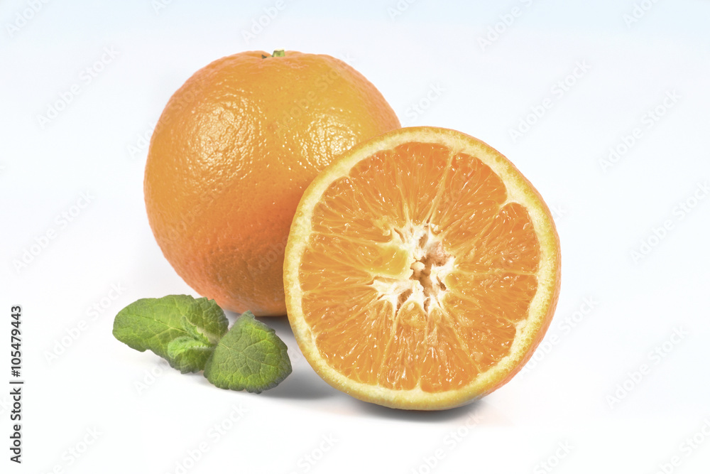 Oranges.One and half of orange fruits with leaf of mint isolated on white background Oranges.One and half of orange fruits with leaf of mint isolated on white background