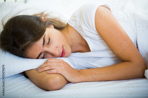 Charming girl sleeping in bed at home