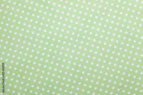 Green fabric background with polka dots