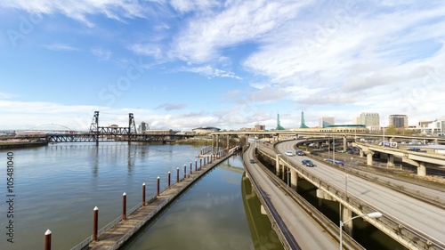 Ultra high definition 4k timelapse movie of fast moving highway traffic and white clouds over downtown Portland Oregon with Steel bridge along Willamette River during rush hour 4096x2304