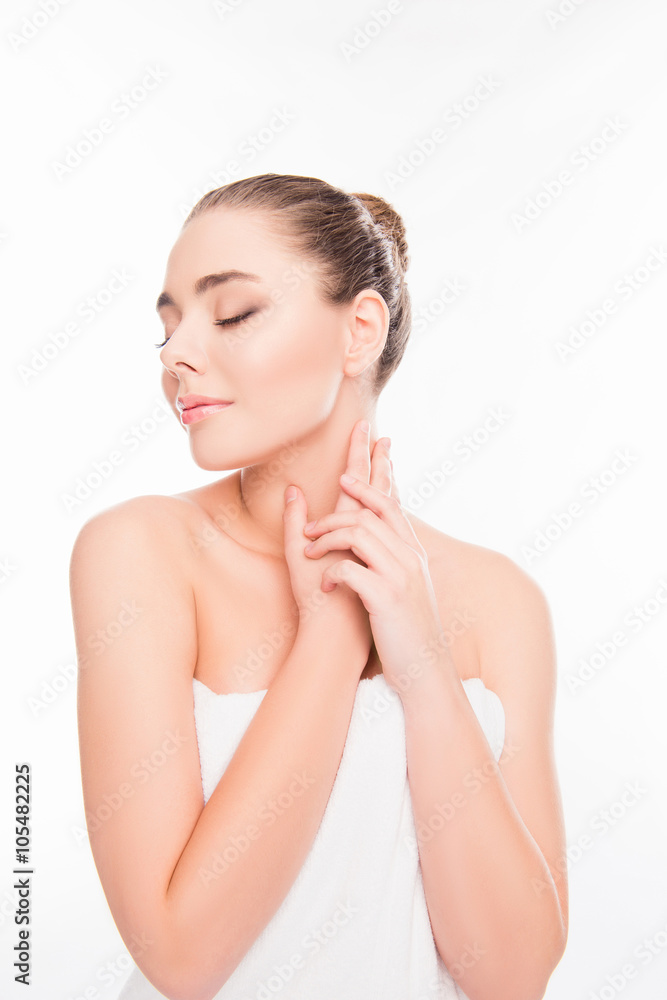 Beautiful girl in towel touching her neck with closed eyes Beautiful girl in towel touching her neck with closed eyes