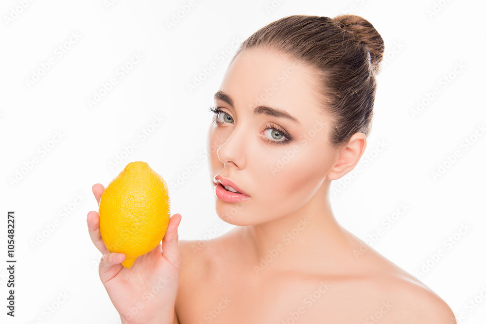Portrait of beautiful woman holding lemon on white background Portrait of beautiful woman holding lemon on white background