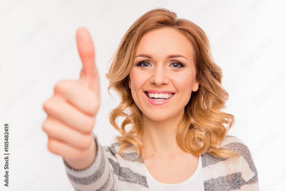 Cheerful girl with curly hair showing thumb up Cheerful girl with curly hair showing thumb up