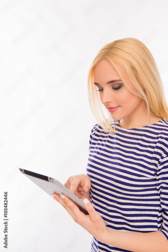 Pretty young woman holding tablet and reading news Pretty young woman holding tablet and reading news
