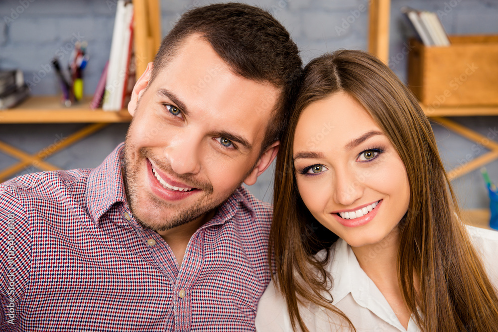 Close up portrait of happy couple huging on the background of wa Close up portrait of happy couple huging on the background of wa
