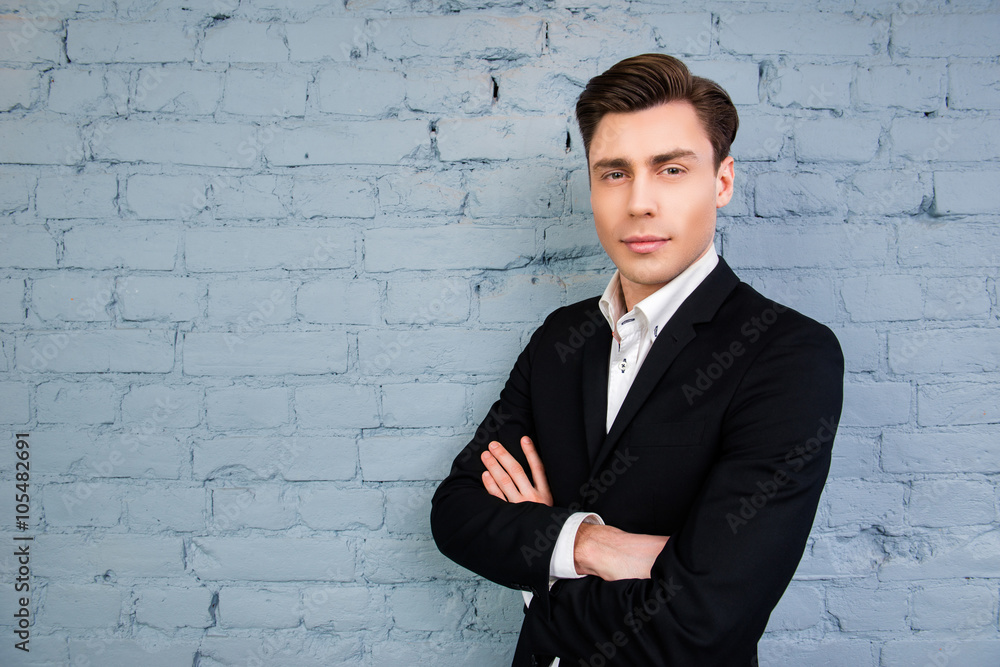 Portrait of serious man with crossed hands on the background of Portrait of serious man with crossed hands on the background of