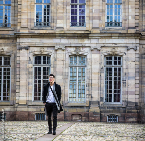 Young man at historic building in Strasbourg, France © theartofphoto