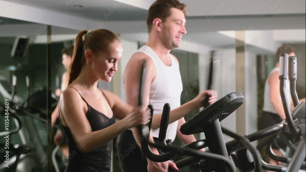 a girl and a guy do in the gym in the sports hall a girl and a guy do in the gym in the sports hall