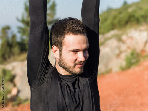 Athlete male runner running on mountain road. Running man joggin