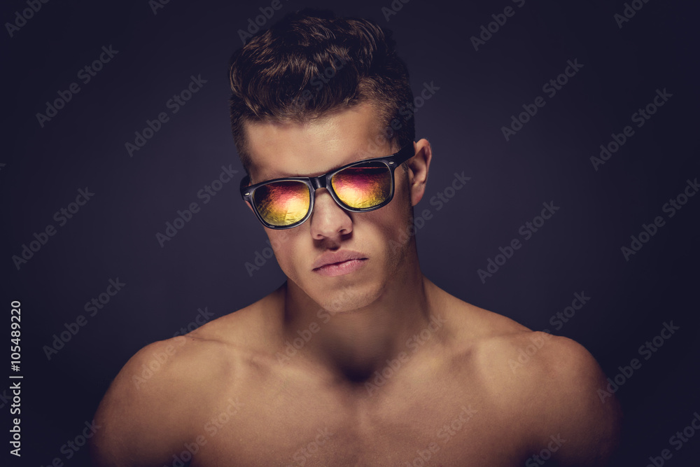 Young muscular guy in sunglasses.