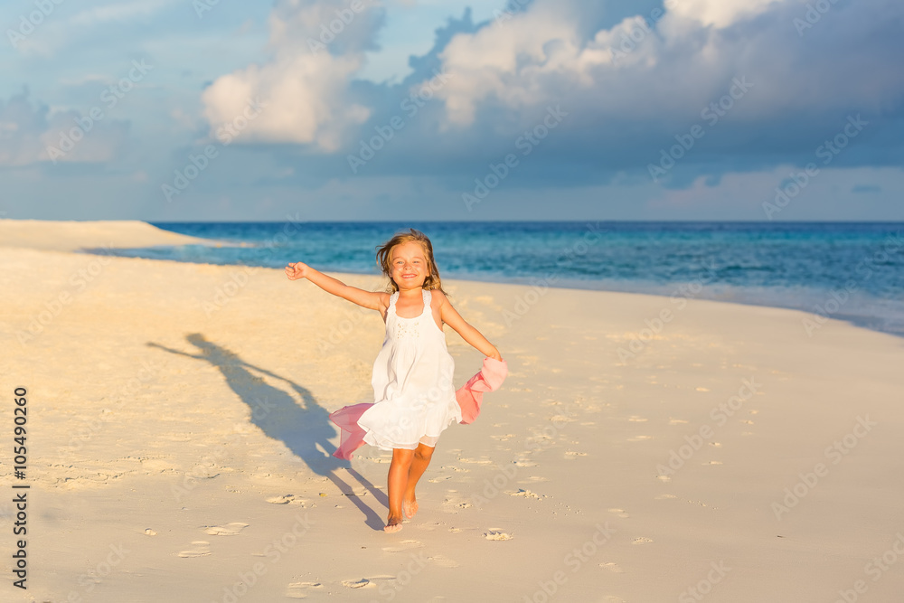 Little girl playing on beautiful ocean beach Little girl playing on beautiful ocean beach