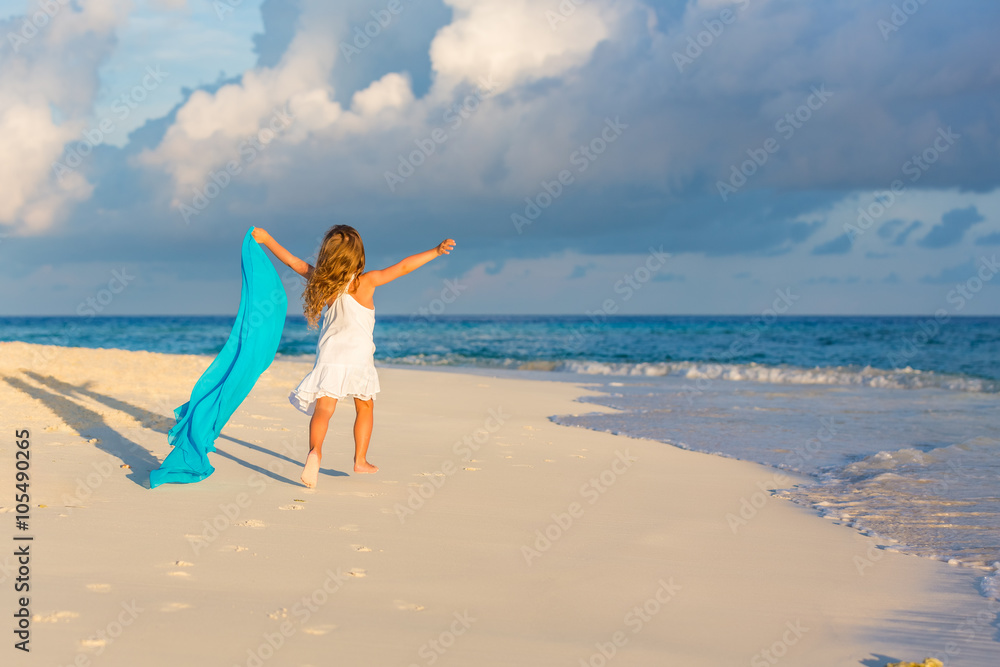 Little girl playing on beautiful ocean beach Little girl playing on beautiful ocean beach