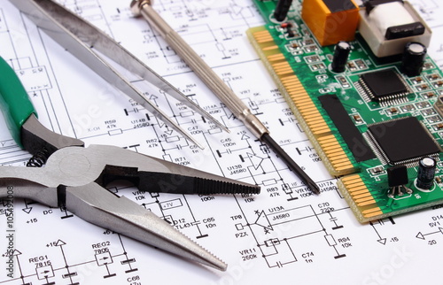 Printed circuit board and precision tools on diagram of electronics, technology