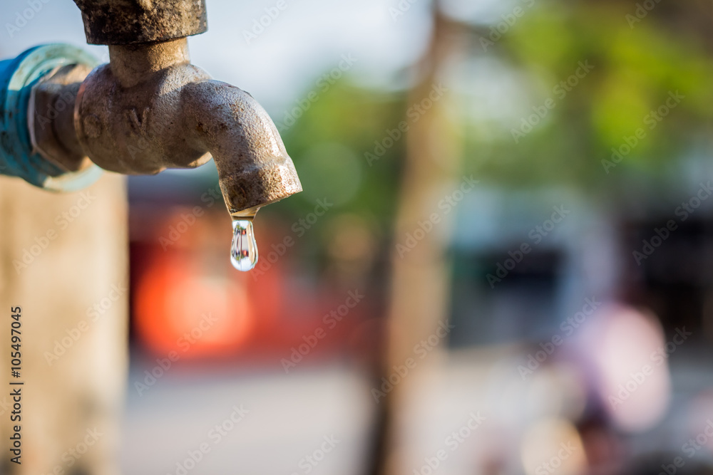 old rusty tap leaking water