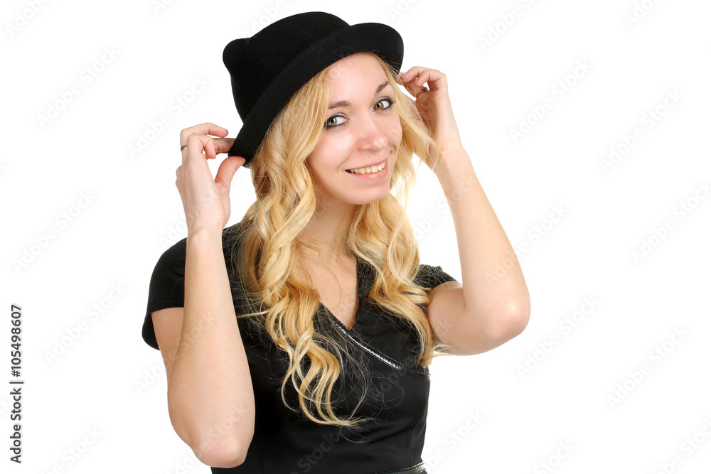 the girl tries on her new hat on a white isolated background the girl tries on her new hat on a white isolated background