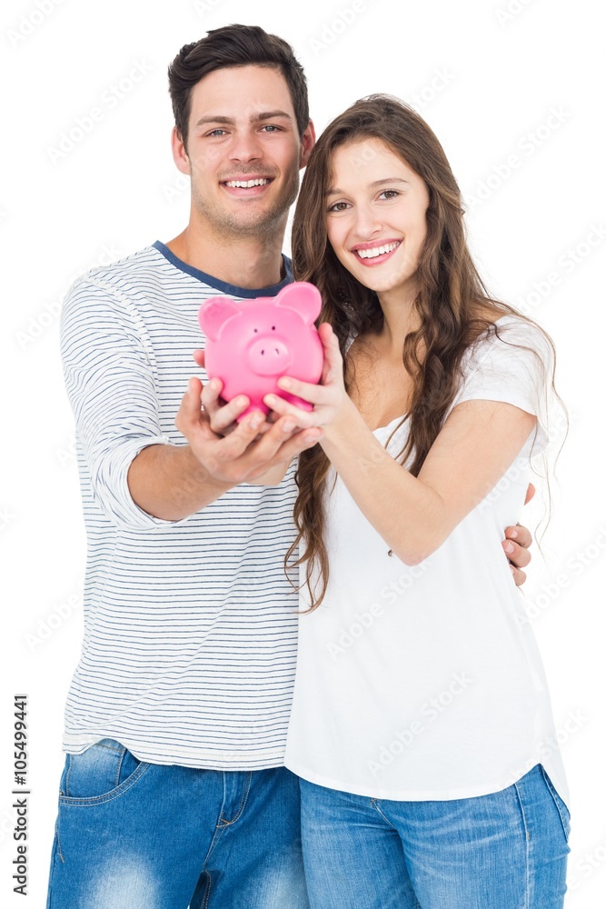 Couple holding piggy bank