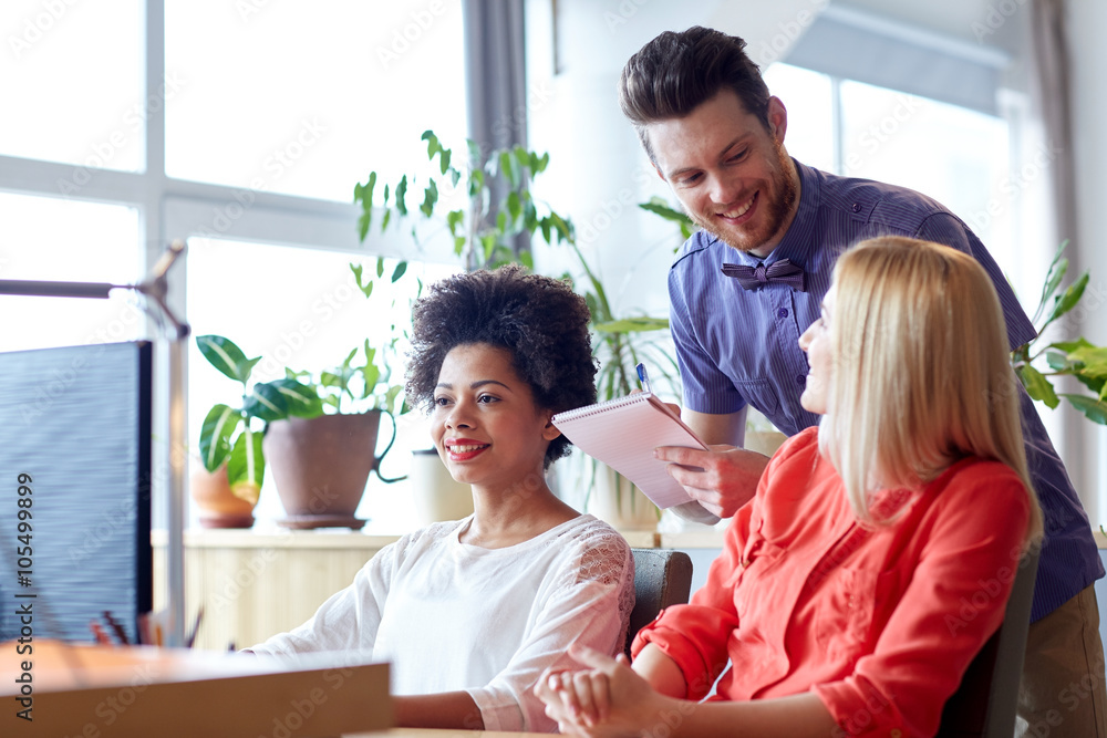 happy creative team with computer in office