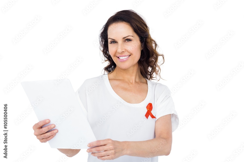 Woman wearing red aids awareness ribbon reading test result Woman wearing red aids awareness ribbon reading test result