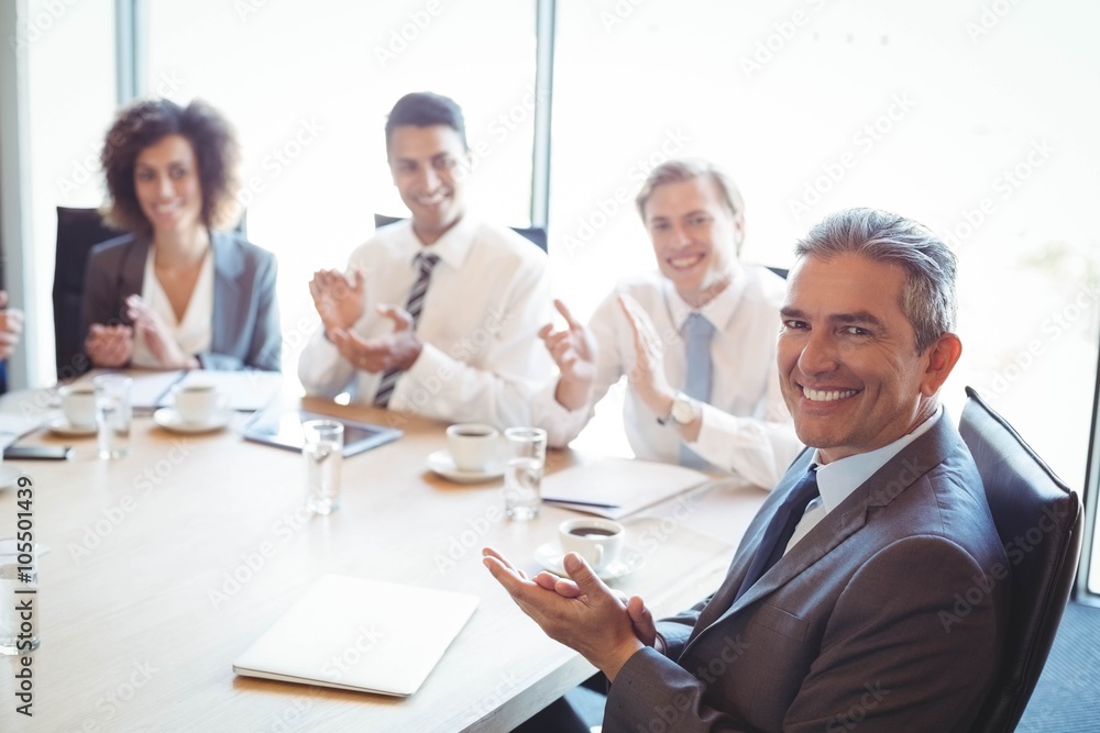 Businesspeople in conference room during meeting Businesspeople in conference room during meeting