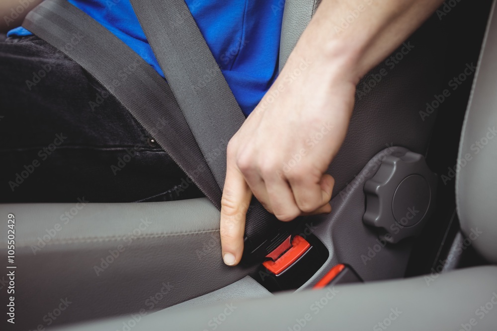 Man buckling his seatbelt Man buckling his seatbelt