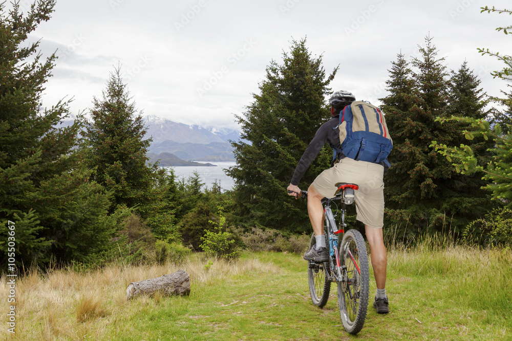 Mountain bike rider at Lake Wanaka, New Zealand Mountain bike rider at Lake Wanaka, New Zealand