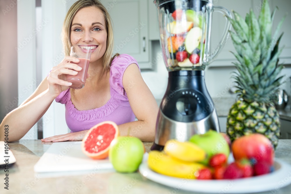 Pretty blonde woman drinking her homemade smoothie Pretty blonde woman drinking her homemade smoothie