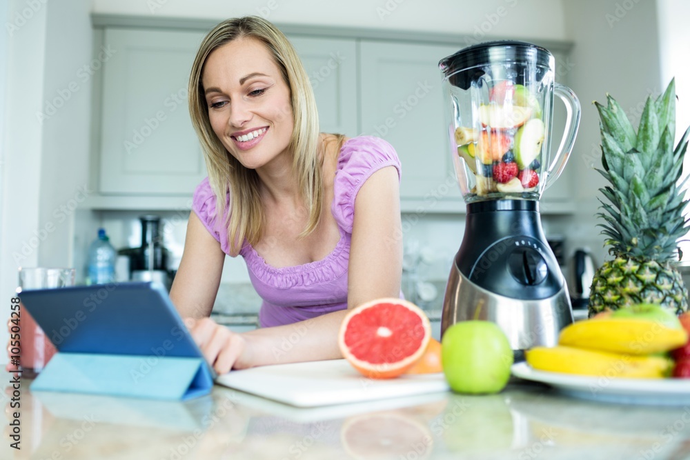Pretty blonde woman using tablet computer Pretty blonde woman using tablet computer
