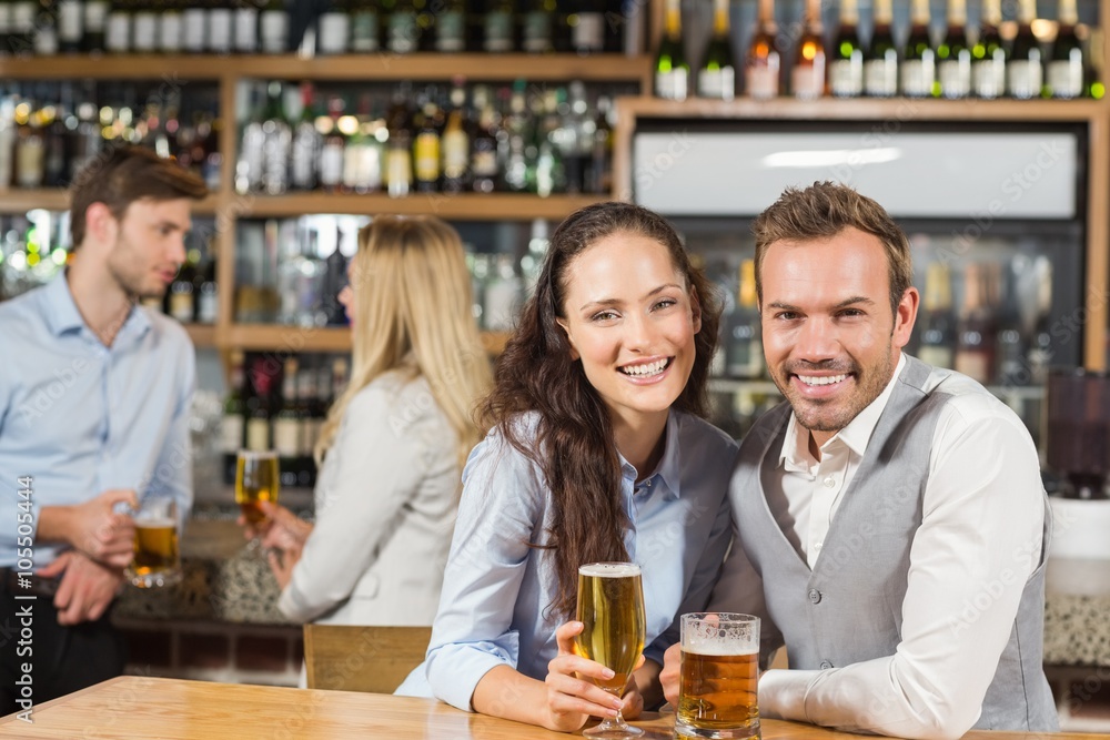 Couples holding beer 