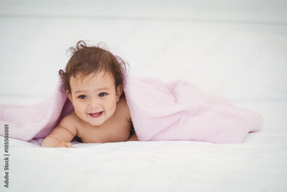 Cute smiling baby lying under blanket Cute smiling baby lying under blanket