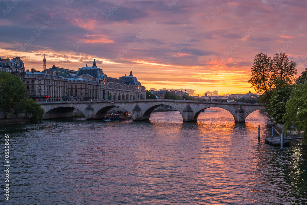 View of the river Seine, the Royal bridge and The Louvre at sunset