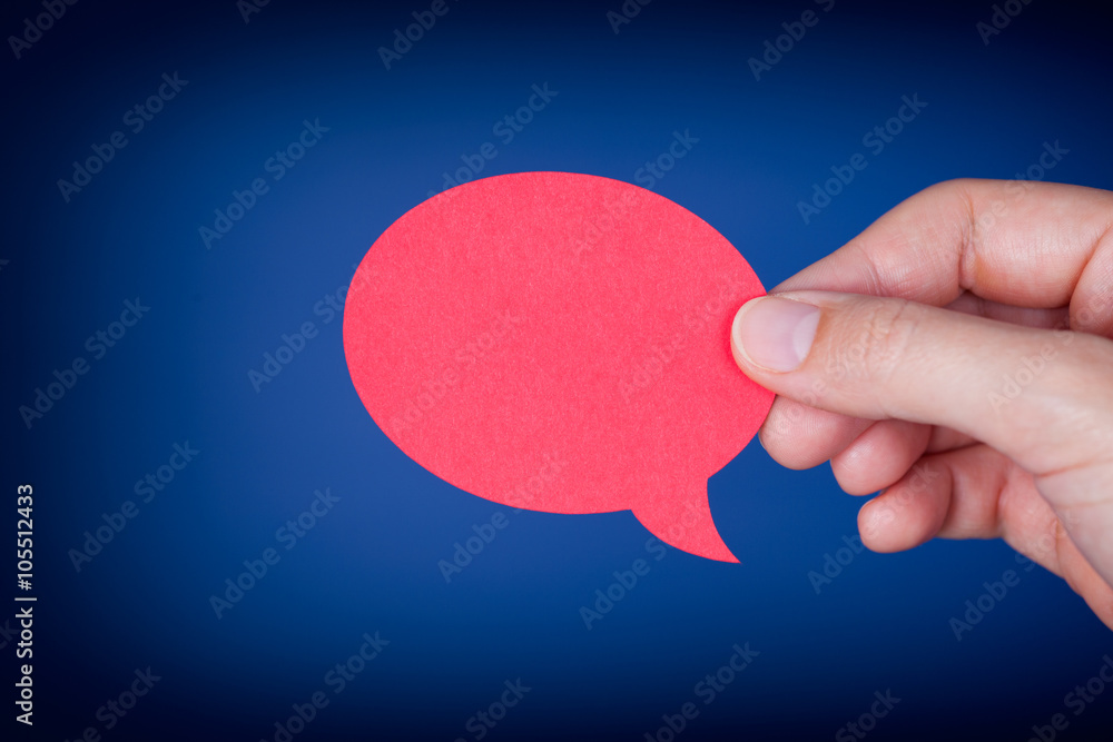 Woman hand holding red speech bubble Woman hand holding red speech bubble