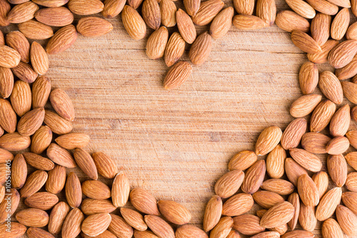 Heart shaped frame of fresh raw almonds