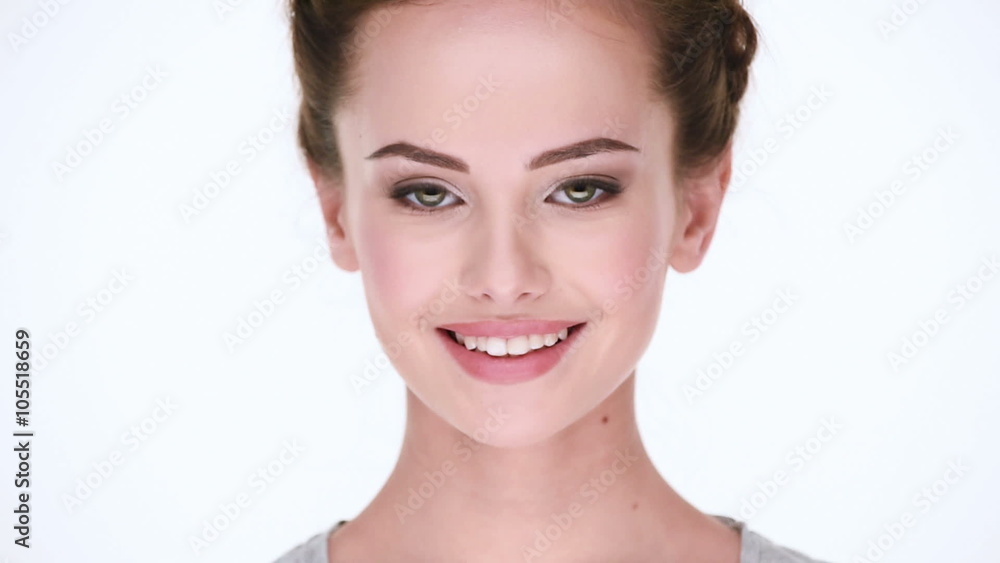 Front portrait of the young beautiful smiling woman looking at camera on white background Front portrait of the young beautiful smiling woman looking at camera on white background