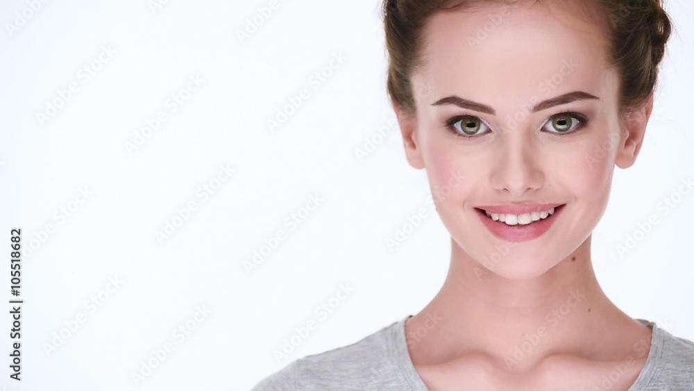 Front portrait of the young beautiful smiling woman looking at camera on white background Front portrait of the young beautiful smiling woman looking at camera on white background