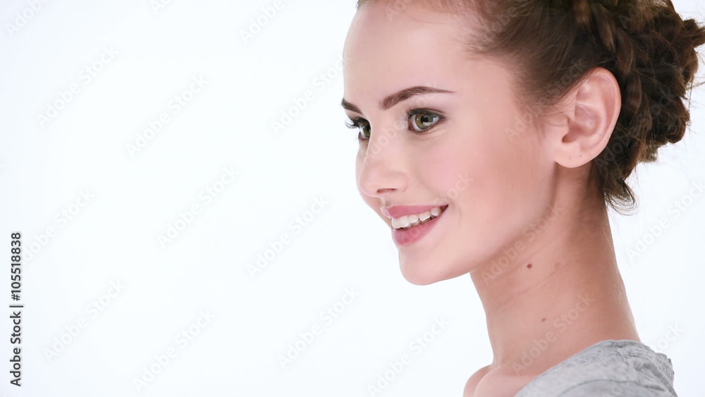 Beautiful healthy smiling woman. Half turn view. over white background Beautiful healthy smiling woman. Half turn view. over white background