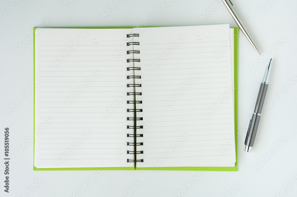 Open notebook with metallic ball pen Open notebook with metallic ball pen