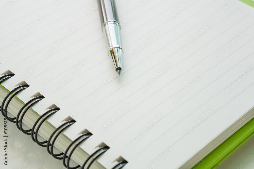 Open notebook with metallic ball pen Open notebook with metallic ball pen