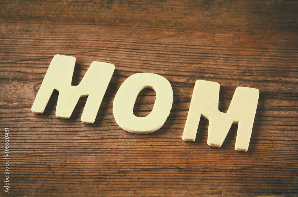 word MOM made with block wooden letters on wooden background. vintage filtered and toned
word MOM made with block wooden letters on wooden background. vintage filtered and toned