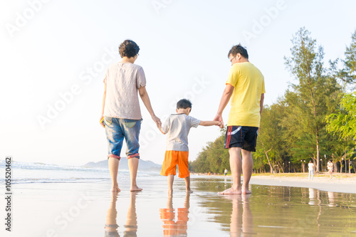 Fototapeta Naklejka Na Ścianę i Meble -  Family having fun on a sandy beach