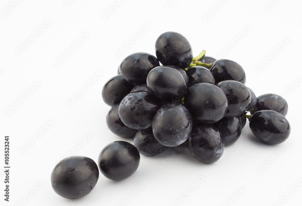 Small bunch of black grapes isolated on white background
