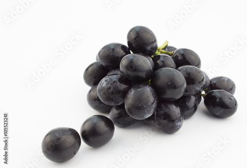 Small bunch of black grapes isolated on white background