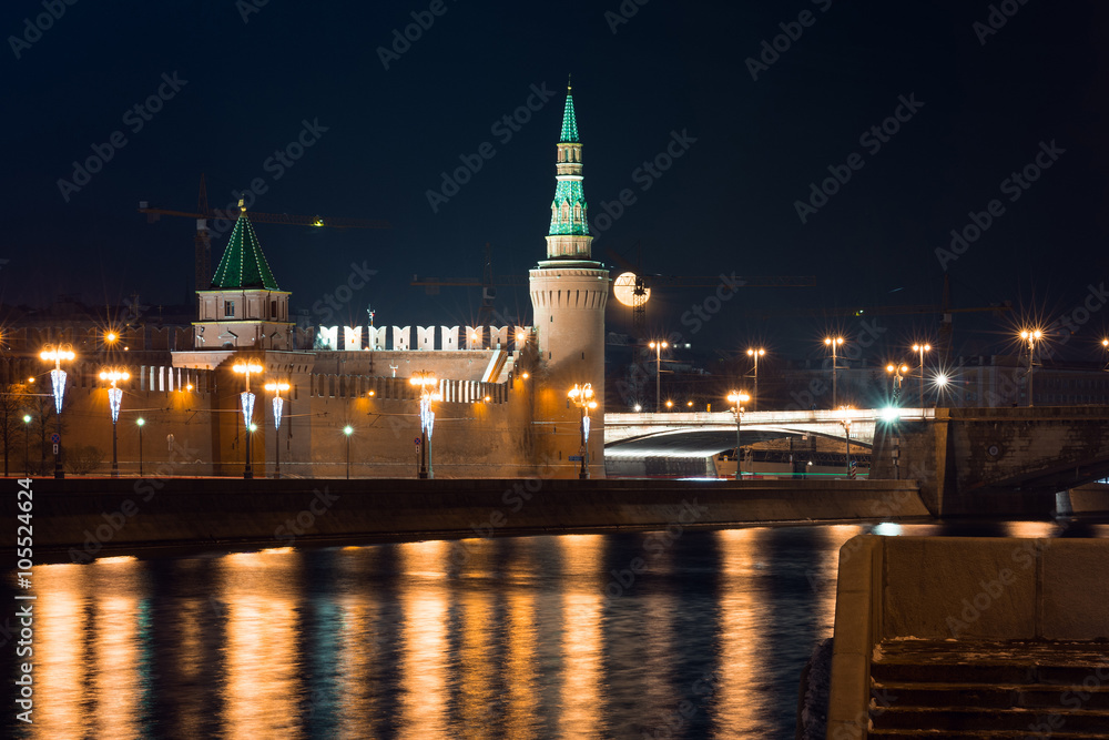 View to embankment of the river, Moscow Kremlin's wall and tower with full moon on background from another side of the river in the night, autumn 2015 View to embankment of the river, Moscow Kremlin's wall and tower with full moon on background from another side of the river in the night, autumn 2015
